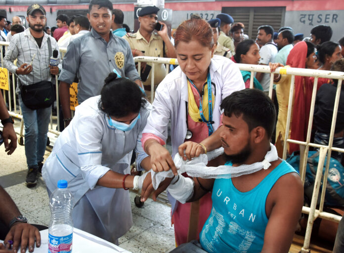 A passenger injured in the Balasore train accident being treated by a healthcare worker