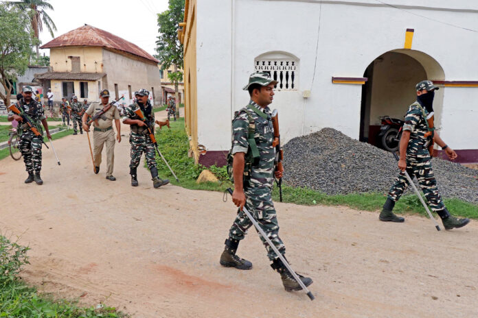 Central Force personnel conduct a route march ahead of the West Bengal panchayat elections at Raipur village
