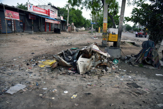 A damaged and burnt vehicle after the violent clash between two groups