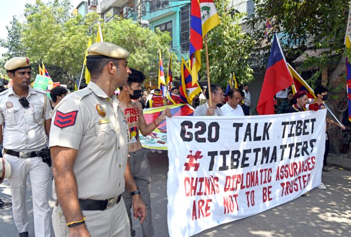 Members of Tibetan community stage a protest near Majnu Ka Tilla against Chinese Government on the eve of G20 Summit