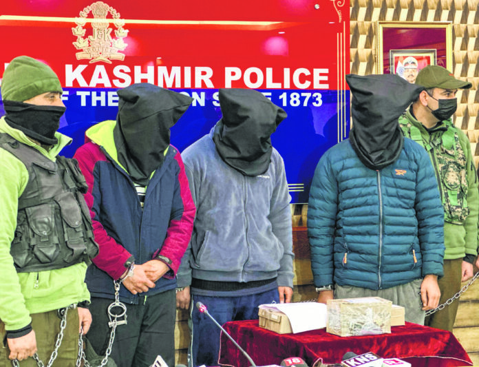 Jammu and Kashmir Police personnel with the three arrested 'hybrid' terrorists