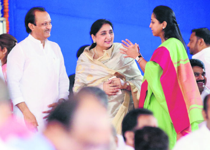 NCP leader Ajit Pawar with his wife Sunetra Pawar(C) and sister Supriya Sule after taking oath as Deputy Chief Minister of Maharashtra