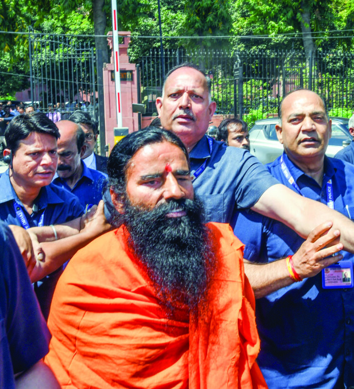 Yog Guru Baba Ramdev leaves the Supreme Court after appearing in the misleading advertisement case