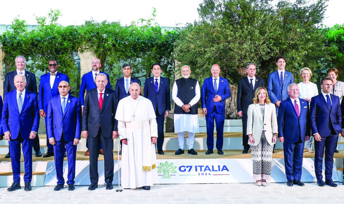 PM in a family photograph during the outreach session of 50th G7 Summit in Apulia, Italy