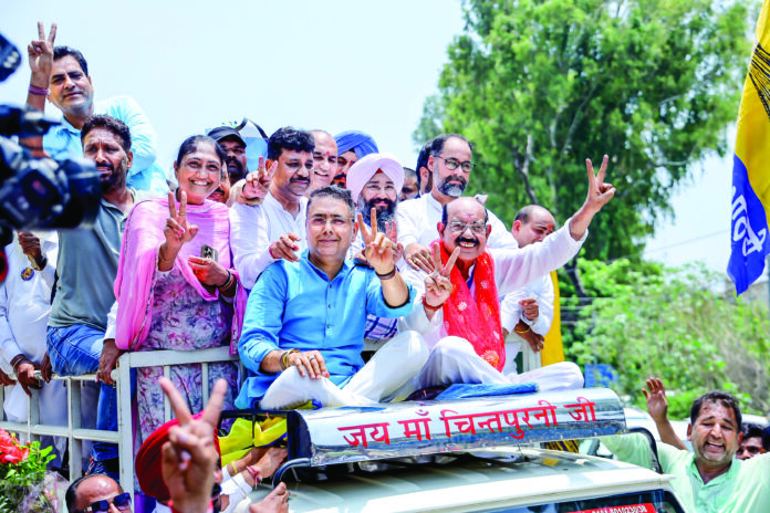 AAP candidate Mohinder Bhagat along with party members shows victory sign during the celebrations after winning the Jalandhar West Assembly by-elections
