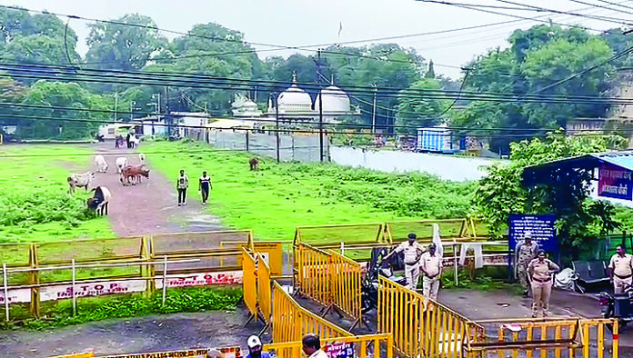 Police personnel stand guard outside the Bhojshala Temple