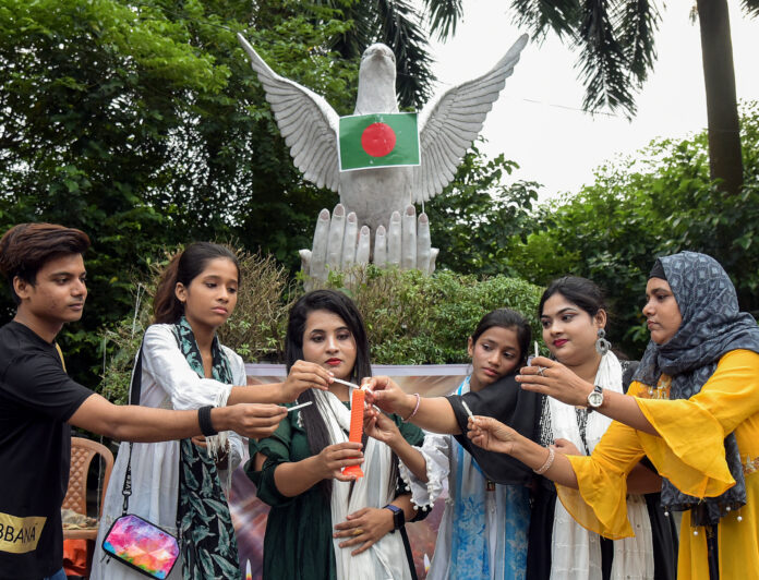 People take part in a candlelight prayer for peace and harmony in Bangladesh