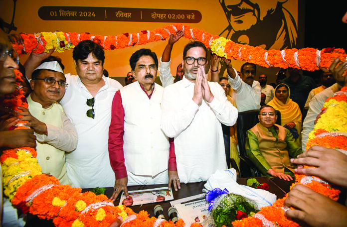 Prashant Kishor being garlanded by supporters during a Muslim cell meeting