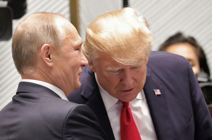 U.S. President Donald Trump and Russian President Vladimir Putin talk before a session of the APEC summit in Danang