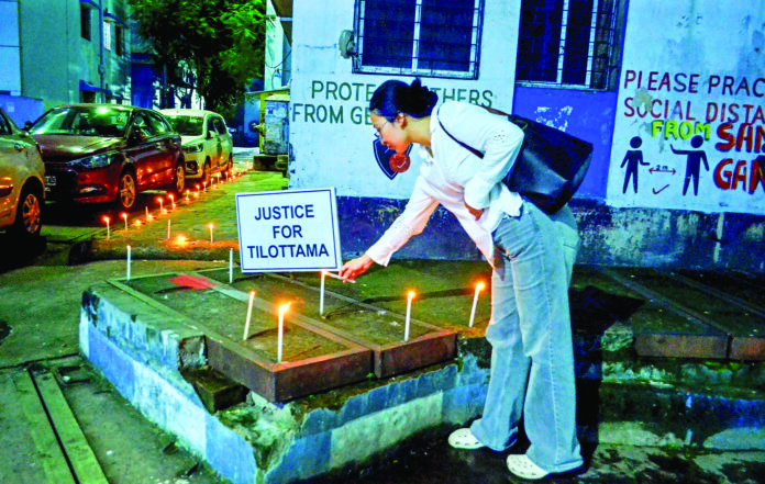 A protester lits candles during the protest against the RG Kar Medical College & Hospital rape-murder case