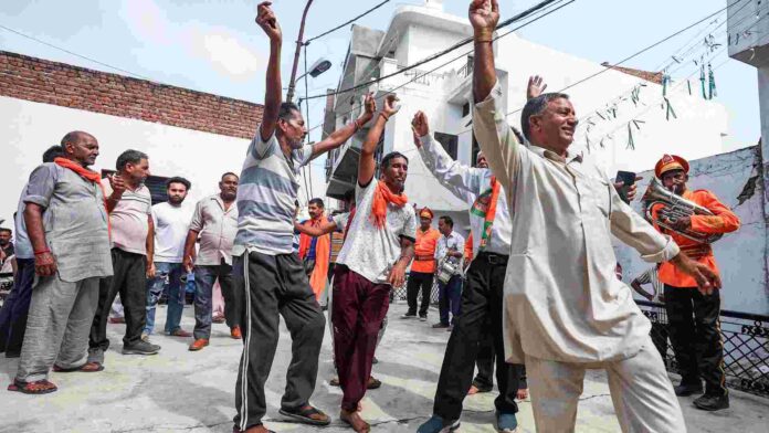 BJP supporters during the third and final phase of Jammu and Kashmir Assembly elections, in Jammu on Tuesday. ANI BJP supporters during the third and final phase of Jammu and Kashmir Assembly elections, in Jammu on Tuesday. ANI