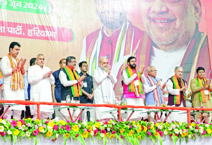 Union Home Minister Amit Shah greets Bharatiya Janata Party (BJP) workers during the first session of the party Executive meeting in the presence of Union Ministers Manohar Lal Khattar and Dharmendra Pradhan and Haryana Chief Minister Nayab Singh Saini, in Panchkula on Saturday. ANI Union Home Minister Amit Shah greets Bharatiya Janata Party (BJP) workers during the first session of the party Executive meeting in the presence of Union Ministers Manohar Lal Khattar and Dharmendra Pradhan and Haryana Chief Minister Nayab Singh Saini, in Panchkula on Saturday. ANI