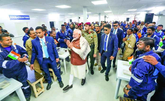 Prime Minister Narendra Modi being welcomed by Indian workers on his arrival at Gulf Spic Labour Camp in Mina Abdullah area, on Saturday. ANI Prime Minister Narendra Modi being welcomed by Indian workers on his arrival at Gulf Spic Labour Camp in Mina Abdullah area, on Saturday. ANI
