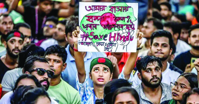 A member of the Bangladeshi Hindu community looks on while holding a banner against violence targeting the country’s minorities during a protest in Dhaka on Aug. 9. (File Photo) A member of the Bangladeshi Hindu community looks on while holding a banner against violence targeting the country’s minorities during a protest in Dhaka on Aug. 9. (File Photo)