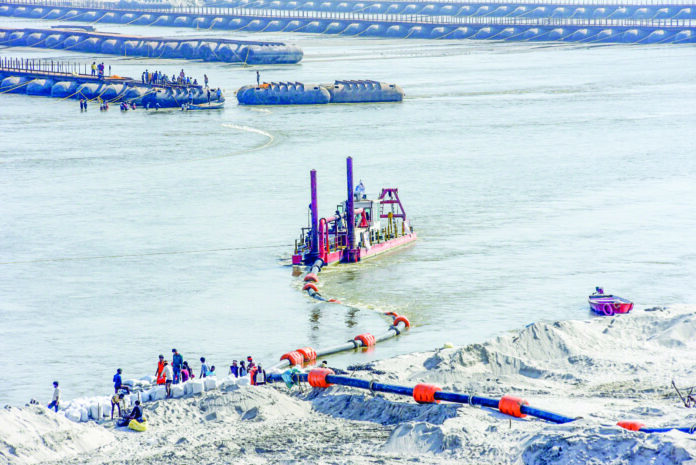 Labourers dredge sand from the river Ganges during preparation ahead of the upcoming Kumbh Mela, in Prayagraj on Saturday. ANI Labourers dredge sand from the river Ganges during preparation ahead of the upcoming Kumbh Mela, in Prayagraj on Saturday. ANI