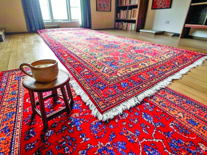 A Kashmiri woollen rug and tea. AI image generated by Grok.