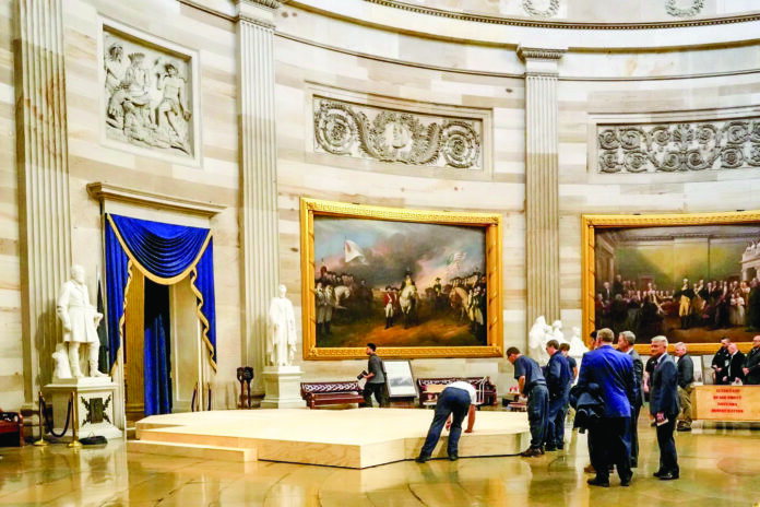Workers build a stage in the US Capitol Rotunda in Washington on Friday for the 60th Presidential inauguration on 20 January, Monday. Workers build a stage in the US Capitol Rotunda in Washington on Friday for the 60th Presidential inauguration on 20 January, Monday.