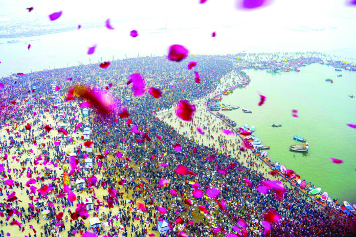 A helicopter showers flowers on devotees gathered to take a dip at Triveni Sangam on the occasion of Makar Sankranti during Maha Kumbh 2025, in Prayagraj on 14 January. ANI A helicopter showers flowers on devotees gathered to take a dip at Triveni Sangam on the occasion of Makar Sankranti during Maha Kumbh 2025, in Prayagraj on 14 January. ANI
