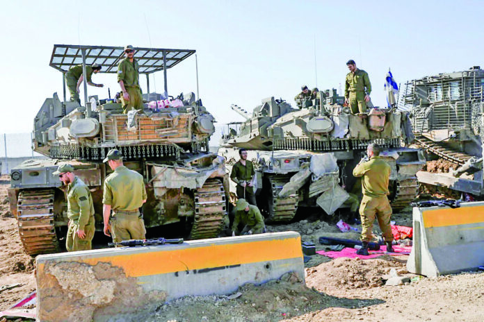 Israeli soldiers work at the Israel-Gaza border after returning from the Gaza strip, Saturday, January 18, 2025, a day ahead of the ceasefire between Israel and Hamas.