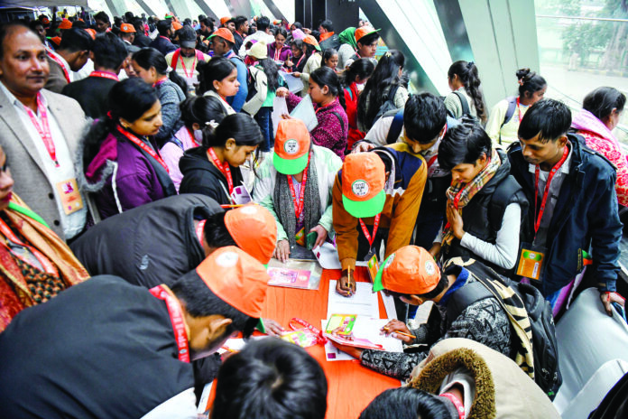 Applicants fill the registration forms during the Rozgar Mela organised by Bharatiya Janata Party (BJP) for the youth living in slums, at Thyagaraj stadium in New Delhi on 23 December 2024. ANI Applicants fill the registration forms during the Rozgar Mela organised by Bharatiya Janata Party (BJP) for the youth living in slums, at Thyagaraj stadium in New Delhi on 23 December 2024. ANI
