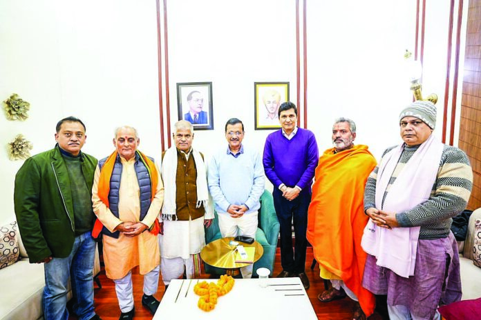 Pujaris and Granthis with AAP National Convener Arvind Kejriwal after the ‘Pujari Granthi Samman Yojana’ announcement, at his residence. Delhi Minister Saurabh Bhardwaj also present, on Monday, December 30, 2024. ANI Pujaris and Granthis with AAP National Convener Arvind Kejriwal after the ‘Pujari Granthi Samman Yojana’ announcement, at his residence. Delhi Minister Saurabh Bhardwaj also present, on Monday, December 30, 2024. ANI