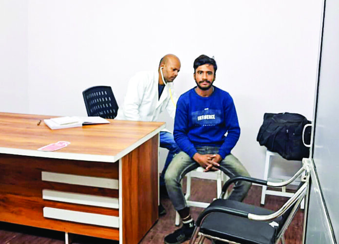 A doctor checks a man at the Central Hospital of Mahakumbhnagar in Prayagraj on Jan 5. ANI