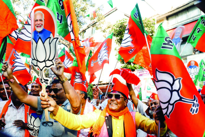 BJP workers celebrate the party’s victory in Delhi Assembly elections, on Saturday. ANI