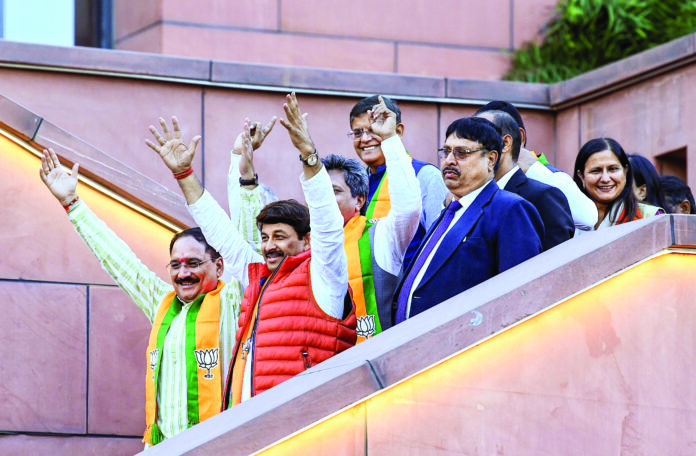 BJP MP Manoj Tiwari and Delhi BJP President Virendra Sachdeva celebrate the party’s victory in the Delhi Assembly elections, at BJP HQ in New Delhi, on Saturday. ANI BJP MP Manoj Tiwari and Delhi BJP President Virendra Sachdeva celebrate the party’s victory in the Delhi Assembly elections, at BJP HQ in New Delhi, on Saturday. ANI