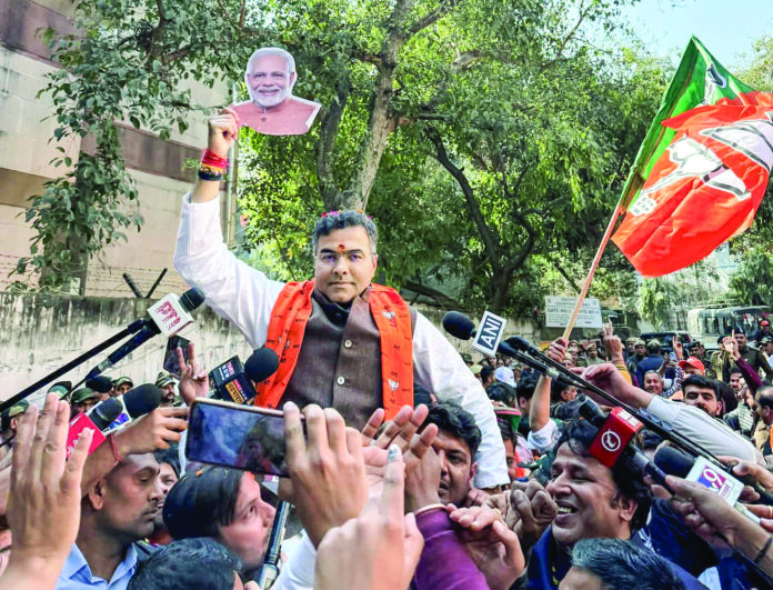 BJP candidate from the New Delhi Assembly seat, Parvesh Verma shows a cutout of Prime Minister Narendra Modi as he celebrates the party’s win in the Delhi Assembly elections, in New Delhi, on February 8. (ANI) BJP candidate from the New Delhi Assembly seat, Parvesh Verma shows a cutout of Prime Minister Narendra Modi as he celebrates the party’s win in the Delhi Assembly elections, in New Delhi, on February 8. (ANI)