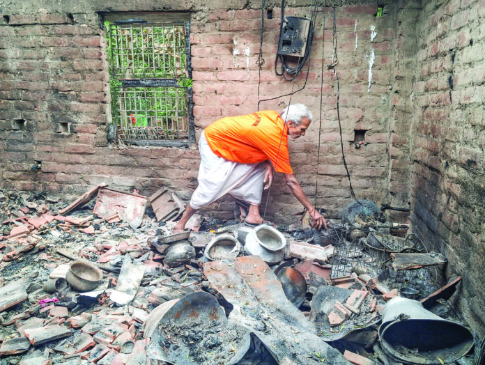 A man goes through the charred remains in a house at the violence-affected Samsergunj area, in Murshidabad on Tuesday. ANI A man goes through the charred remains in a house at the violence-affected Samsergunj area, in Murshidabad on Tuesday. ANI
