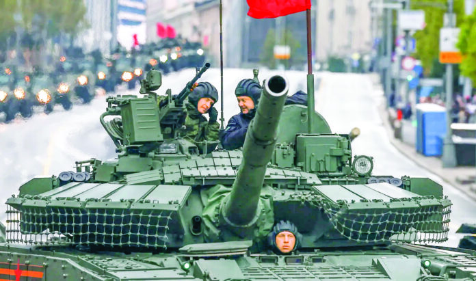 Russian service members atop armored vehicles during a rehearsal for a military armored parade marking the 80th anniversary of victory over Nazi Germany in World War II in central Moscow, Russia. Russian service members atop armored vehicles during a rehearsal for a military armored parade marking the 80th anniversary of victory over Nazi Germany in World War II in central Moscow, Russia.