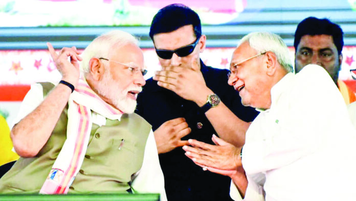 Prime Minister Narendra Modi and Bihar Chief Minister Nitish Kumar in conversation during a public meeting, in Rohtas on May 30, 2025. (ANI)
