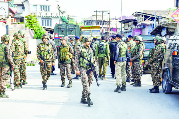 Security personnel stand guard, at Pampore in Pulwama. (ANI Photo)